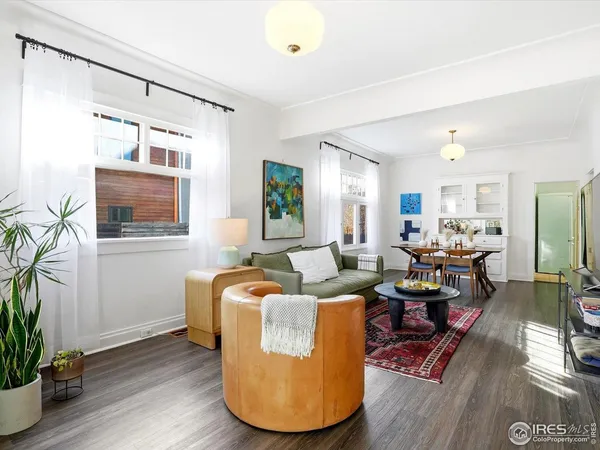 a living room with fireplace furniture and a potted plant