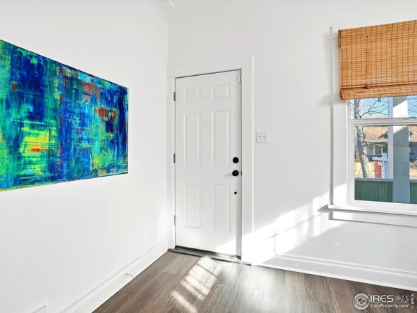 a view of an entryway with wooden floor
