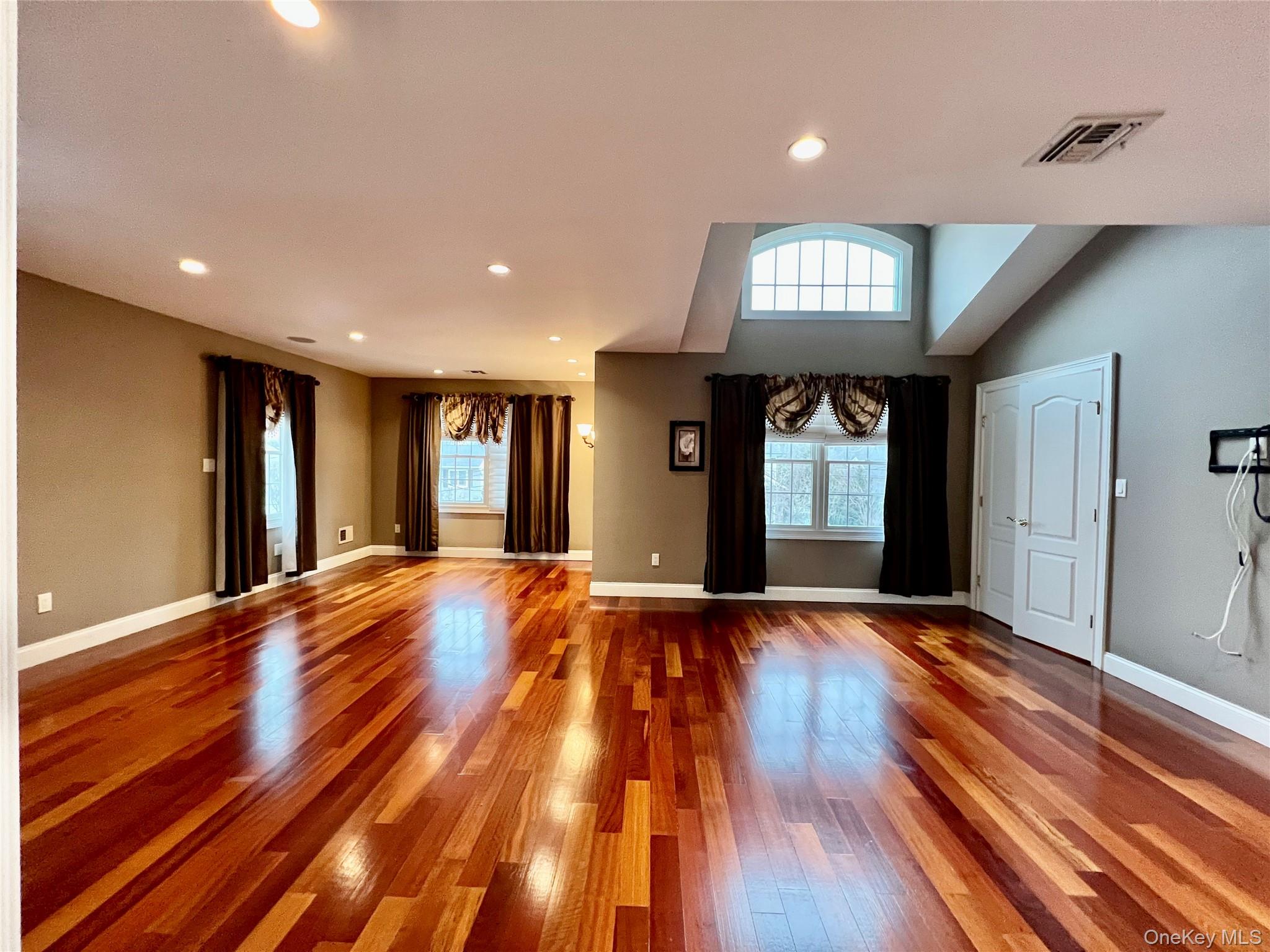 3683 Orchard Road Wantagh, NY 11793 - Photo 18 of 42 a view of an empty room with wooden floor and a window