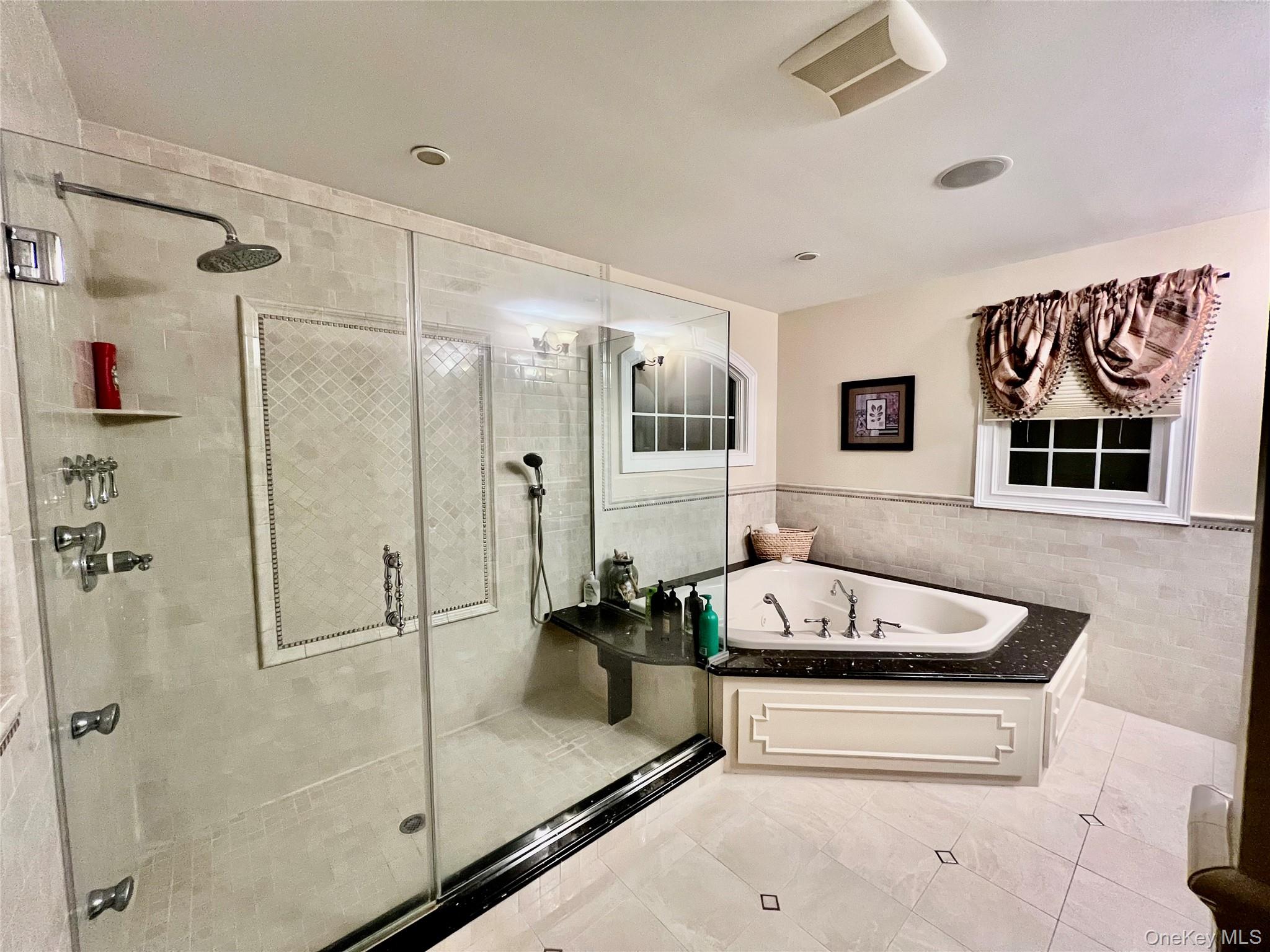 3683 Orchard Road Wantagh, NY 11793 - Photo 22 of 42 a bathroom with a tub sink and mirror