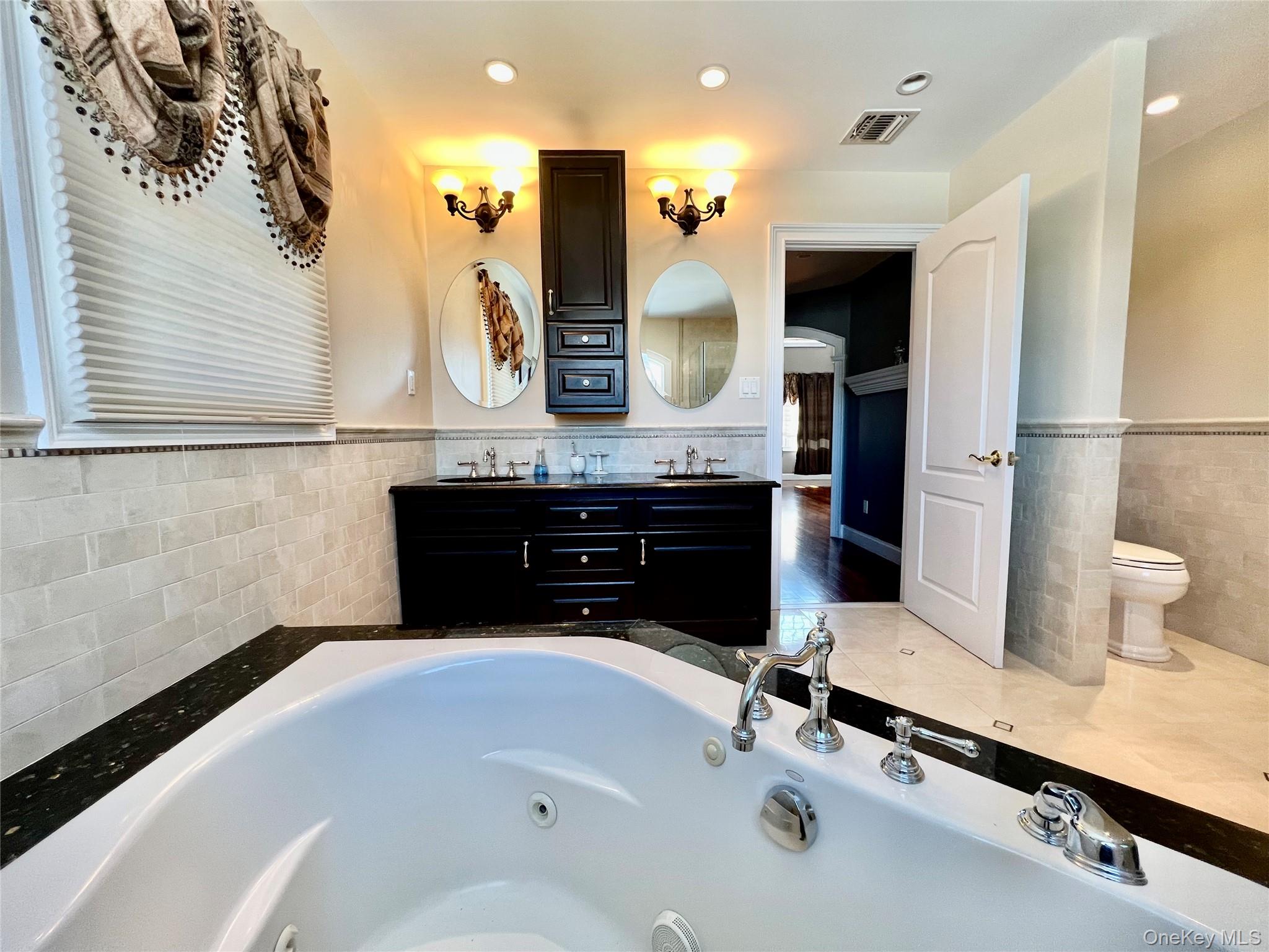 3683 Orchard Road Wantagh, NY 11793 - Photo 23 of 42 a bathroom with a sink and a mirror