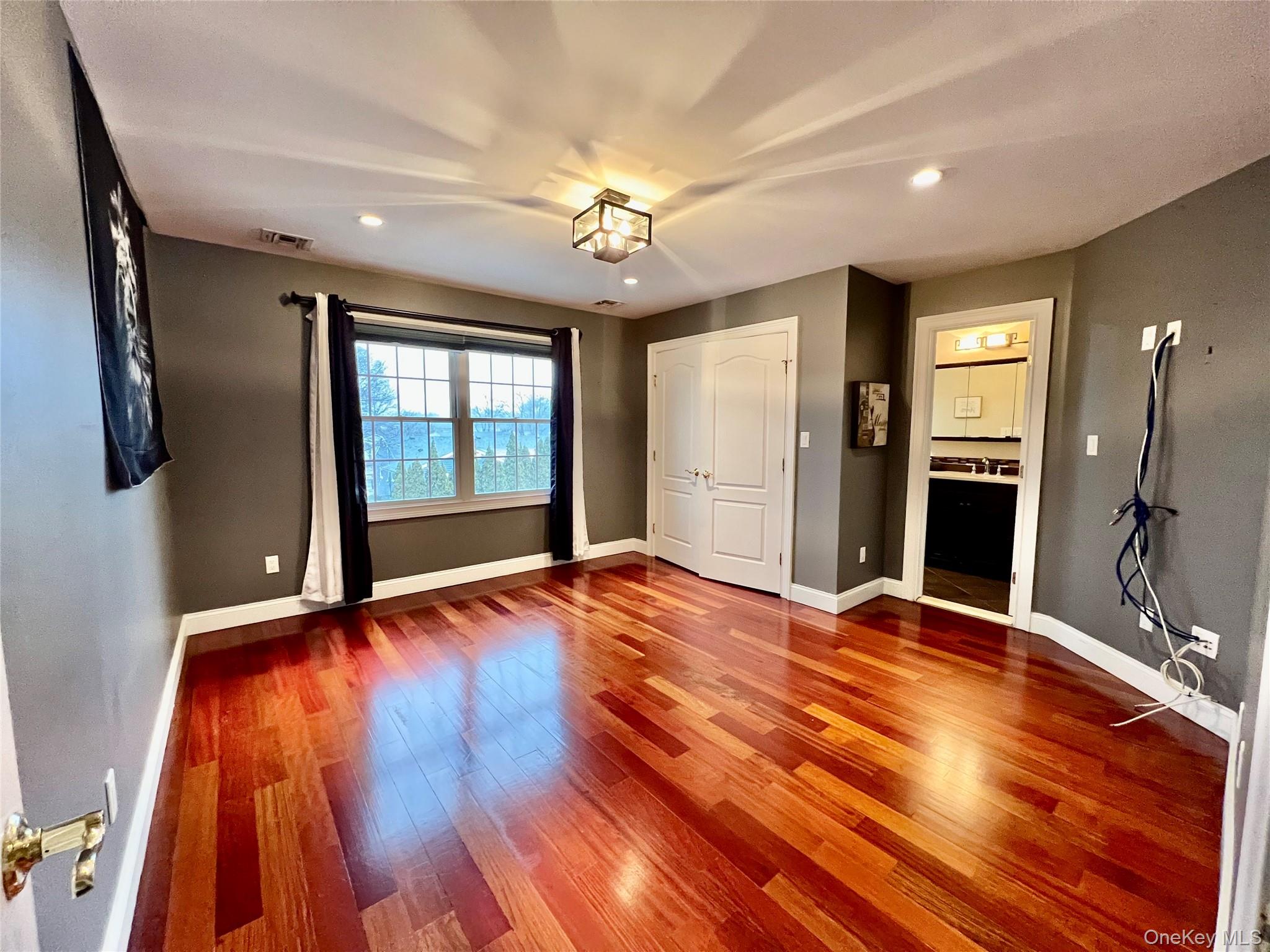 3683 Orchard Road Wantagh, NY 11793 - Photo 27 of 42 a view of an empty room with window and wooden floor