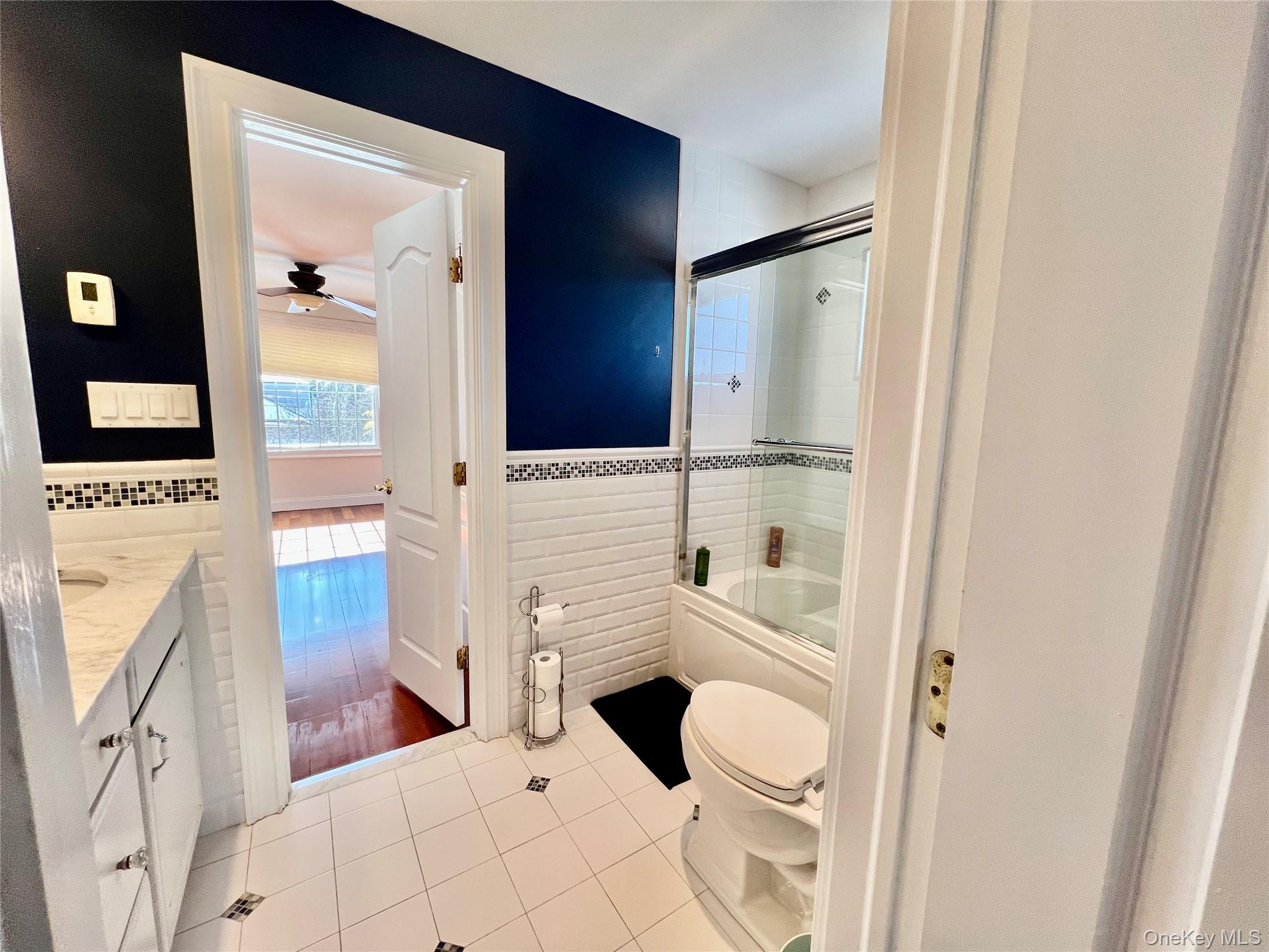 3683 Orchard Road Wantagh, NY 11793 - Photo 30 of 42 a bathroom with a granite countertop sink toilet and shower