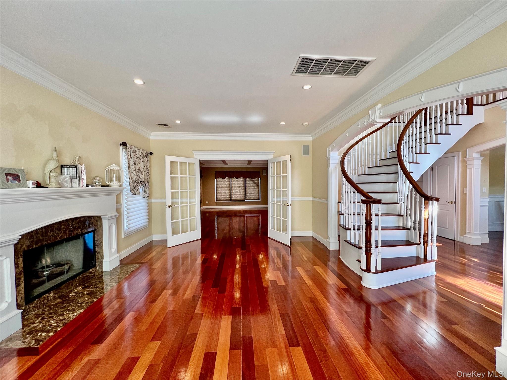 3683 Orchard Road Wantagh, NY 11793 - Photo 7 of 42 a living room with wooden floors and a fireplace
