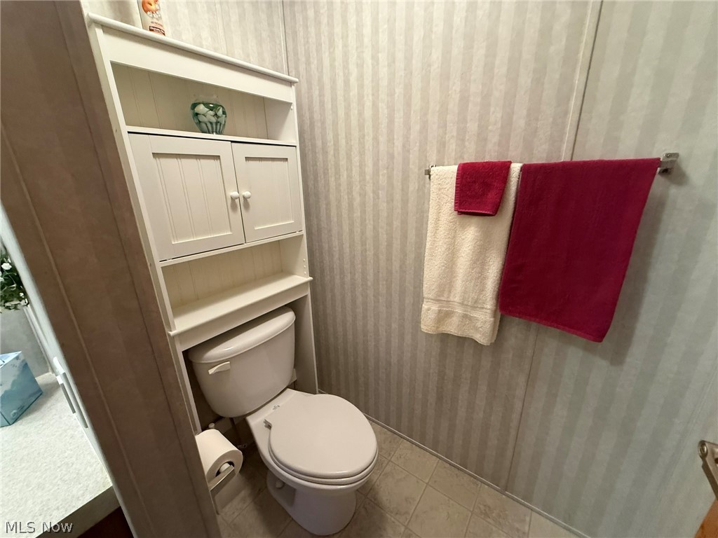 2933 Rabbit Drive Dennison, OH 44621 - Photo 19 of 28 Half bathroom featuring wallpapered walls and light tile patterned flooring