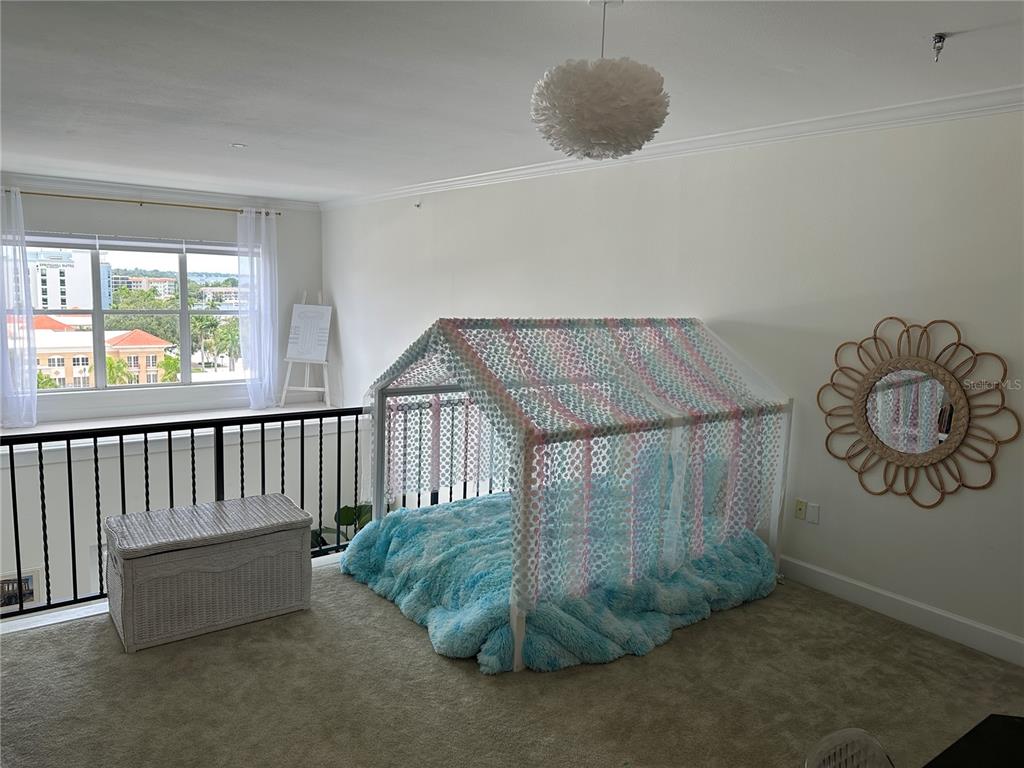 808 3rd Avenue West, Unit 701 Bradenton, FL 34205 - Photo 14 of 45 a bedroom with a bed and window