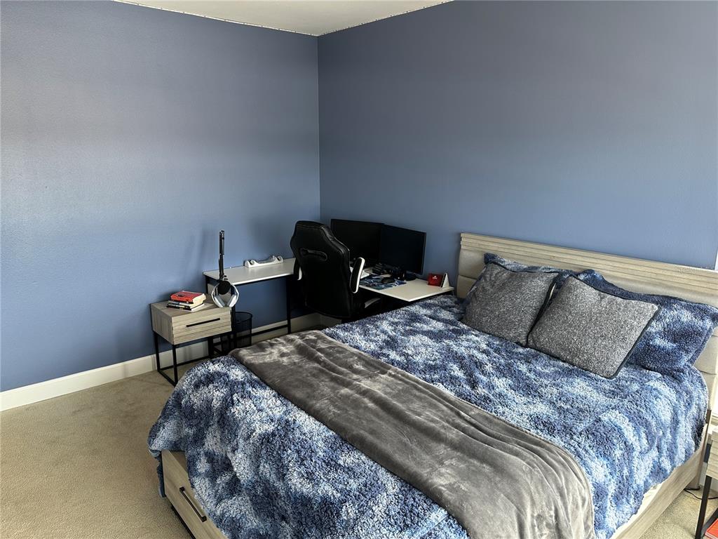 808 3rd Avenue West, Unit 701 Bradenton, FL 34205 - Photo 24 of 45 a bedroom with a bed and a lamp on the dresser