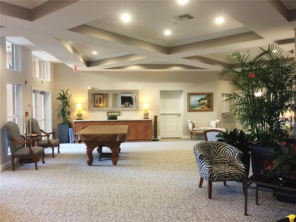 808 3rd Avenue West, Unit 701 Bradenton, FL 34205 - Photo 42 of 45 a living room with furniture and a potted plant