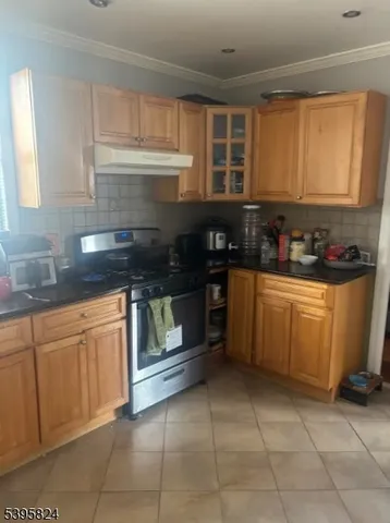 a kitchen with a sink a stove and cabinets