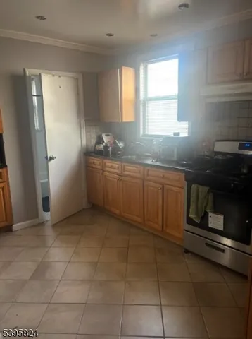 a kitchen with stainless steel appliances granite countertop a sink and a refrigerator