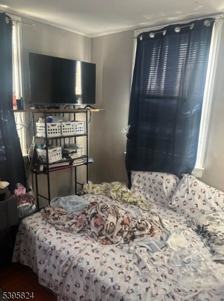 11 Naples Avenue Belleville, NJ 07109 - Photo 5 of 9 a bedroom with a bed and a flat screen tv