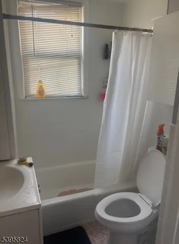 a white toilet sitting next to a bath tub