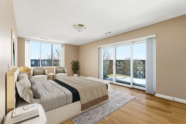 a bedroom with a large bed and a large window with outer view