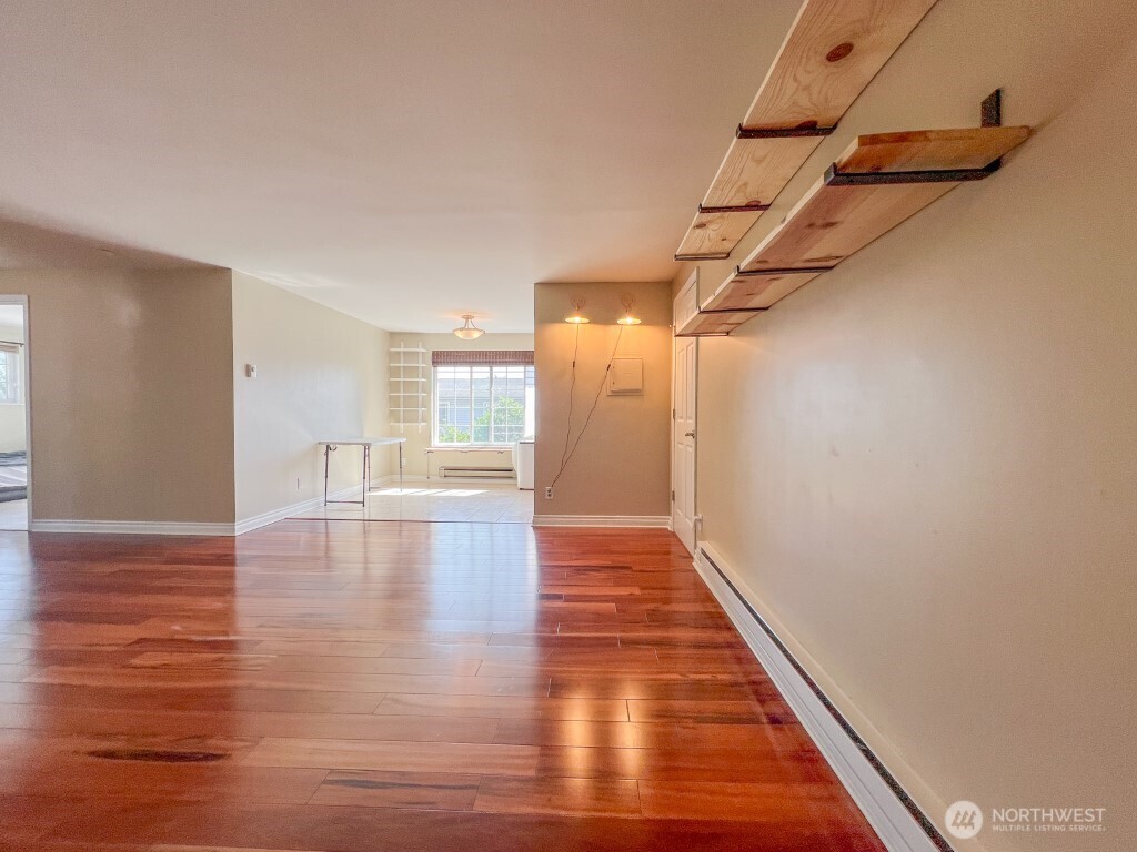 633 Northwest 85th Street, Unit 301 Seattle, WA 98117 - Photo 11 of 34 a view of a hallway with wooden floor