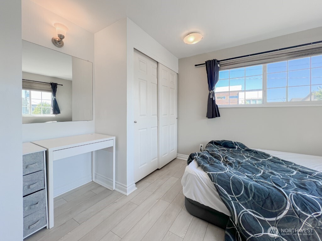 633 Northwest 85th Street, Unit 301 Seattle, WA 98117 - Photo 14 of 34 a bedroom with a bed and a dresser