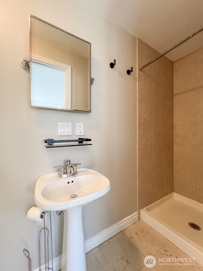 633 Northwest 85th Street, Unit 301 Seattle, WA 98117 - Photo 16 of 34 a bathroom with a sink and a mirror