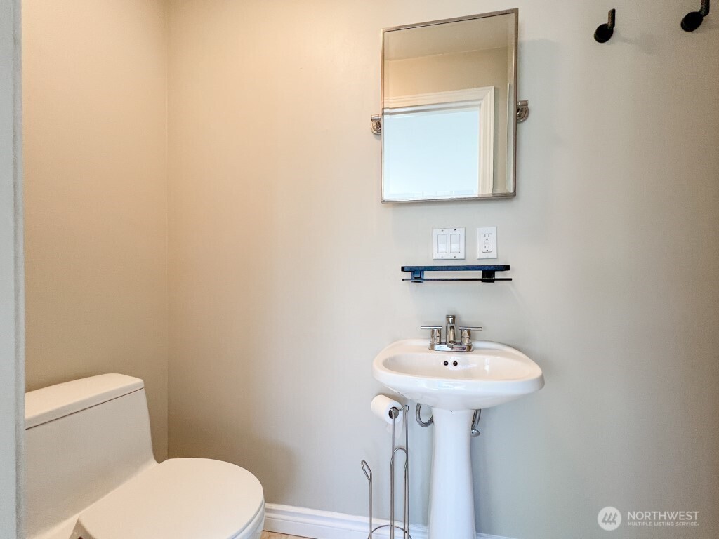 633 Northwest 85th Street, Unit 301 Seattle, WA 98117 - Photo 17 of 34 a bathroom with a sink a mirror and a toilet