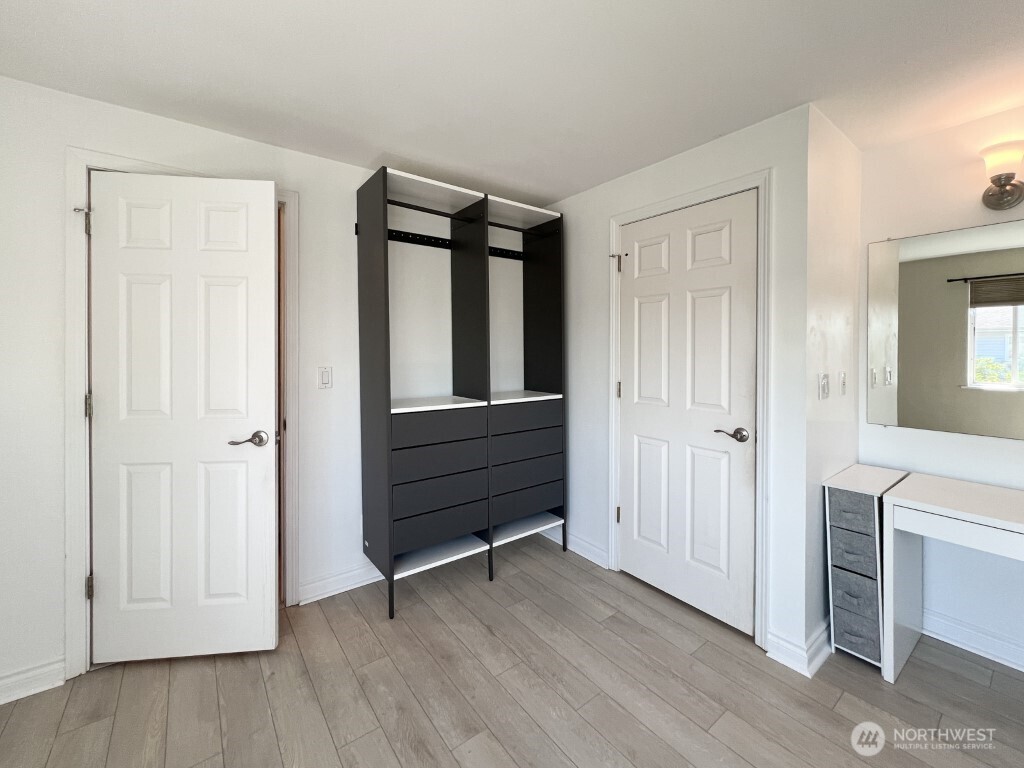633 Northwest 85th Street, Unit 301 Seattle, WA 98117 - Photo 18 of 34 a view of a room with wooden floor and cabinet