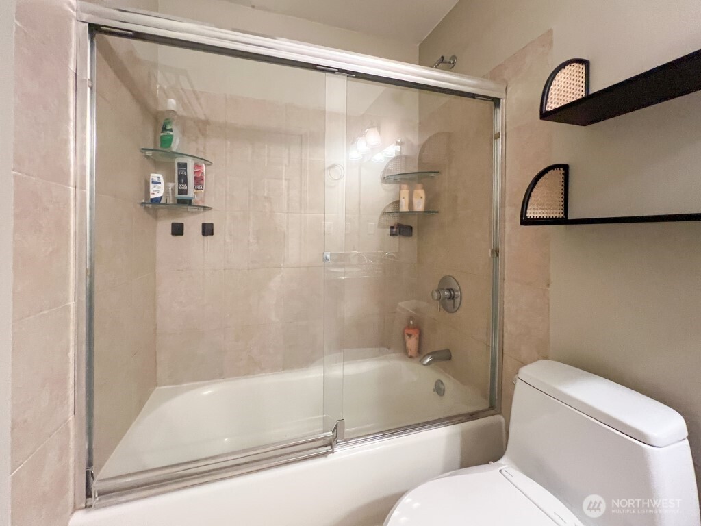 633 Northwest 85th Street, Unit 301 Seattle, WA 98117 - Photo 22 of 34 a bathroom with a toilet and a shower