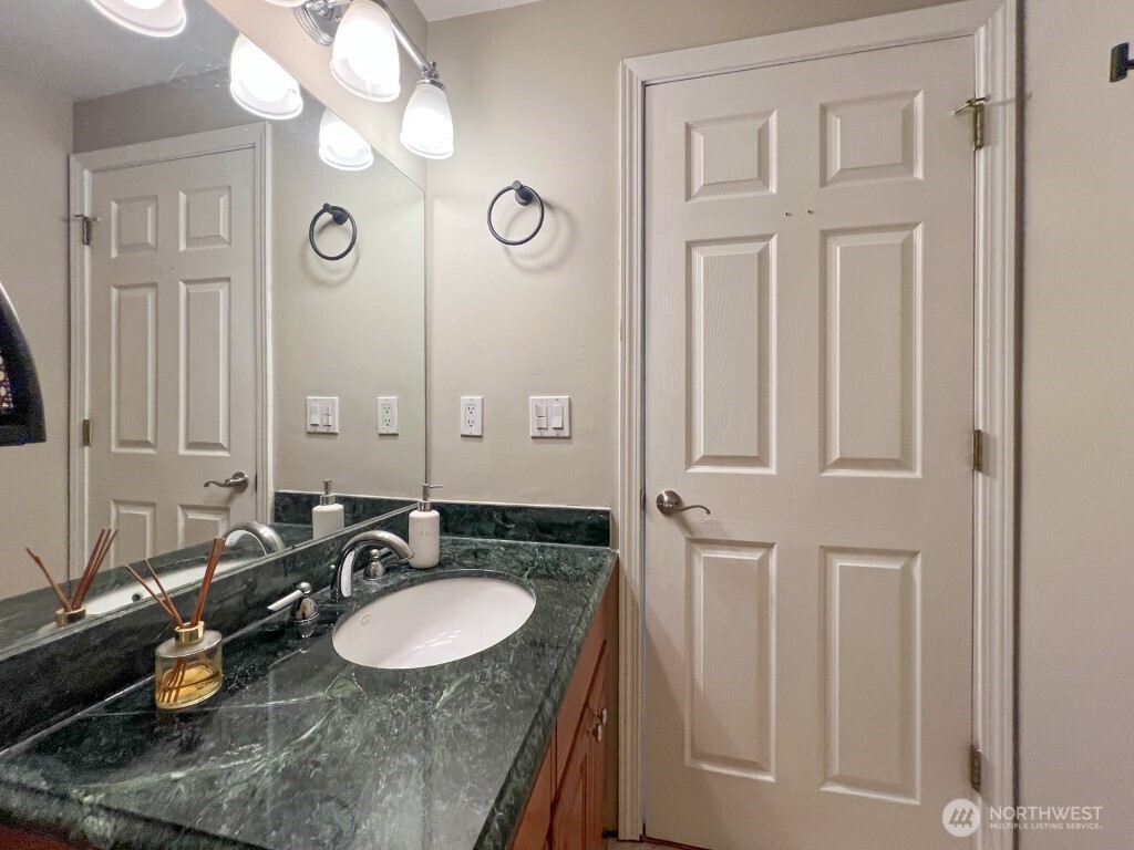 633 Northwest 85th Street, Unit 301 Seattle, WA 98117 - Photo 23 of 34 a bathroom with double vanity and a mirror
