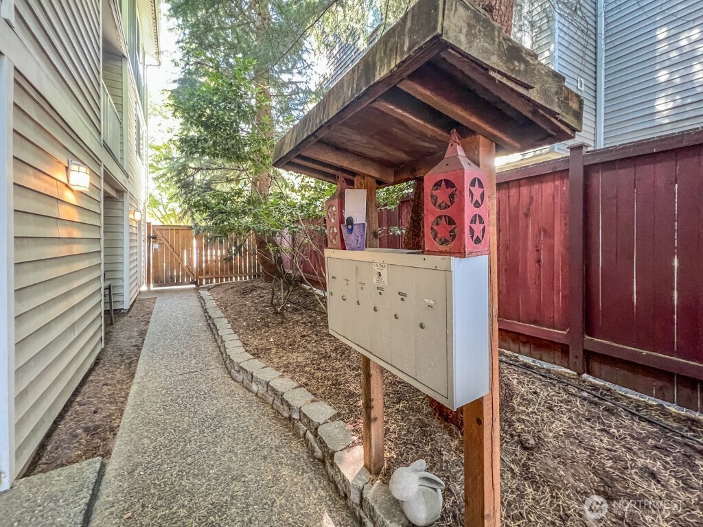 633 Northwest 85th Street, Unit 301 Seattle, WA 98117 - Photo 30 of 34 a view of a pathway door with wooden fence