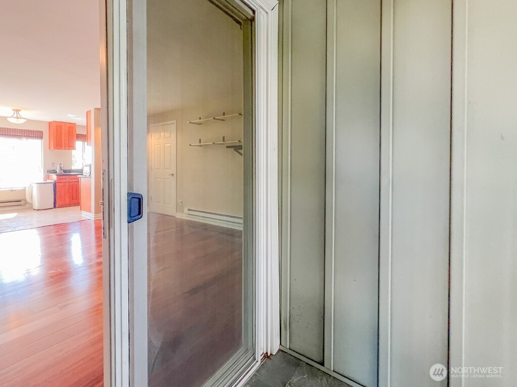 633 Northwest 85th Street, Unit 301 Seattle, WA 98117 - Photo 8 of 34 a view of a hallway with wooden floor