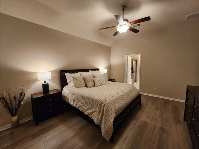 a bedroom with bed and a chandelier