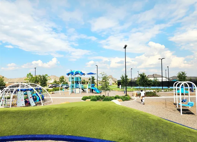 a view of a park with swings and slides