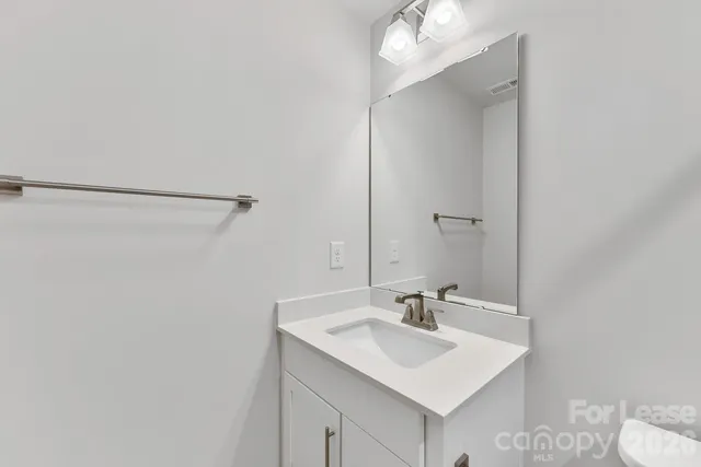 a bathroom with a sink vanity and a mirror