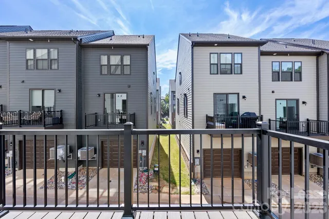 a view of a brick house with large windows