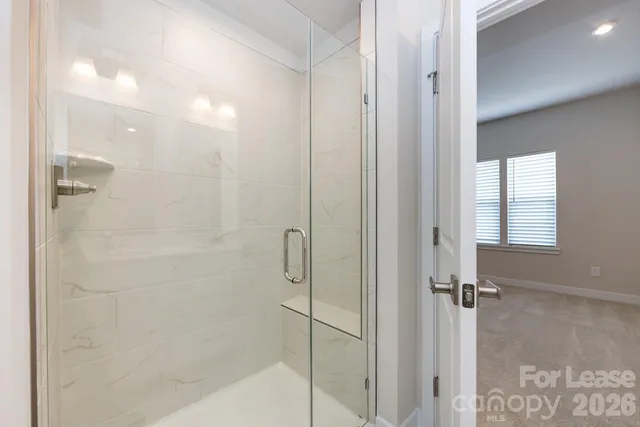 a bathroom with a glass shower door