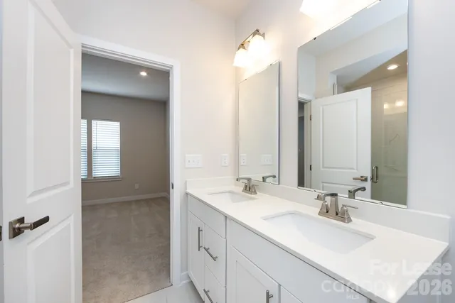 a bathroom with 2 sink and a mirror