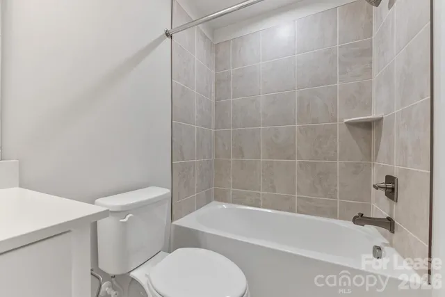 a bathroom with a bathtub and a toilet