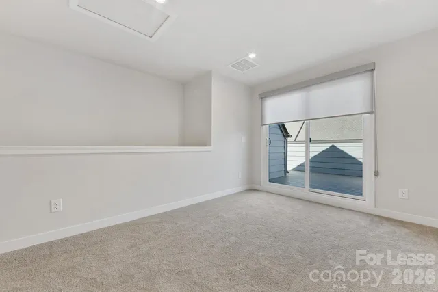 an empty room with wooden floor and cabinet