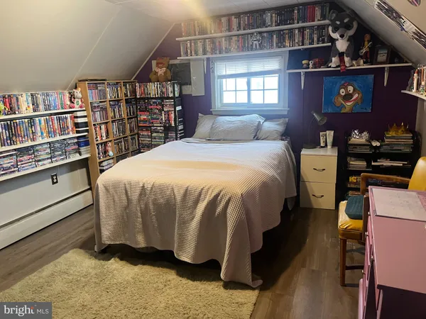 a bed sitting in a bedroom next to a book shelf