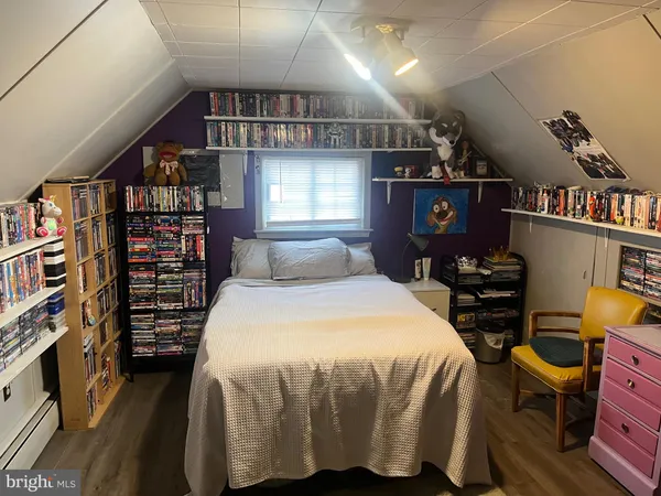a bed sitting in a bedroom next to a book shelf