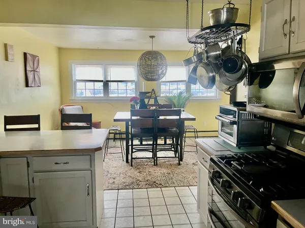a kitchen with a stove and a chair