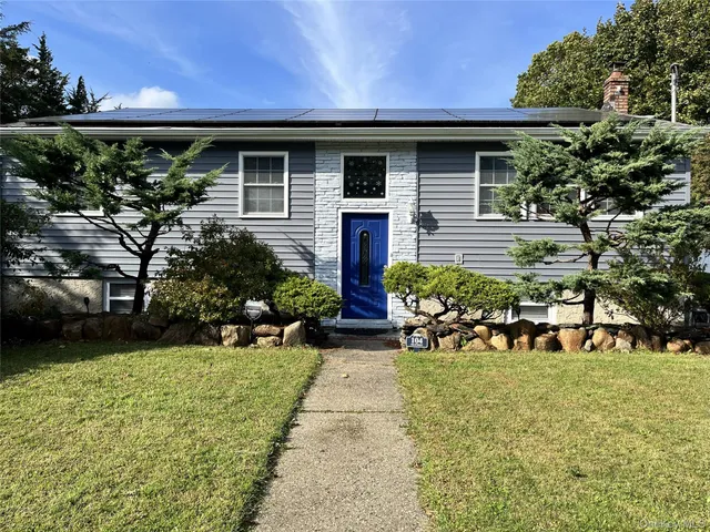 a front view of a house with garden
