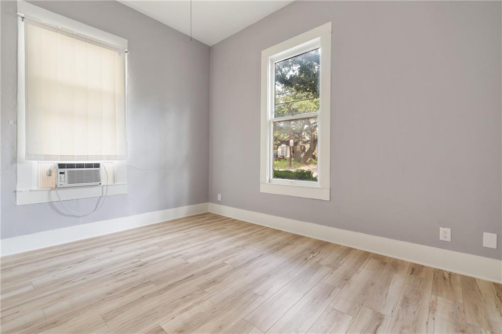 3210 Hampton Road, Unit A B C Austin, TX 78705 - Photo 36 of 42 Bright interior space featuring light wood-finish flooring, neutral gray walls, and white baseboards