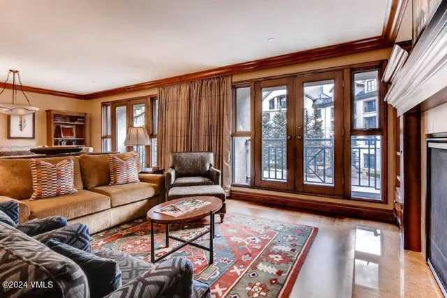 a living room with furniture and a floor to ceiling window