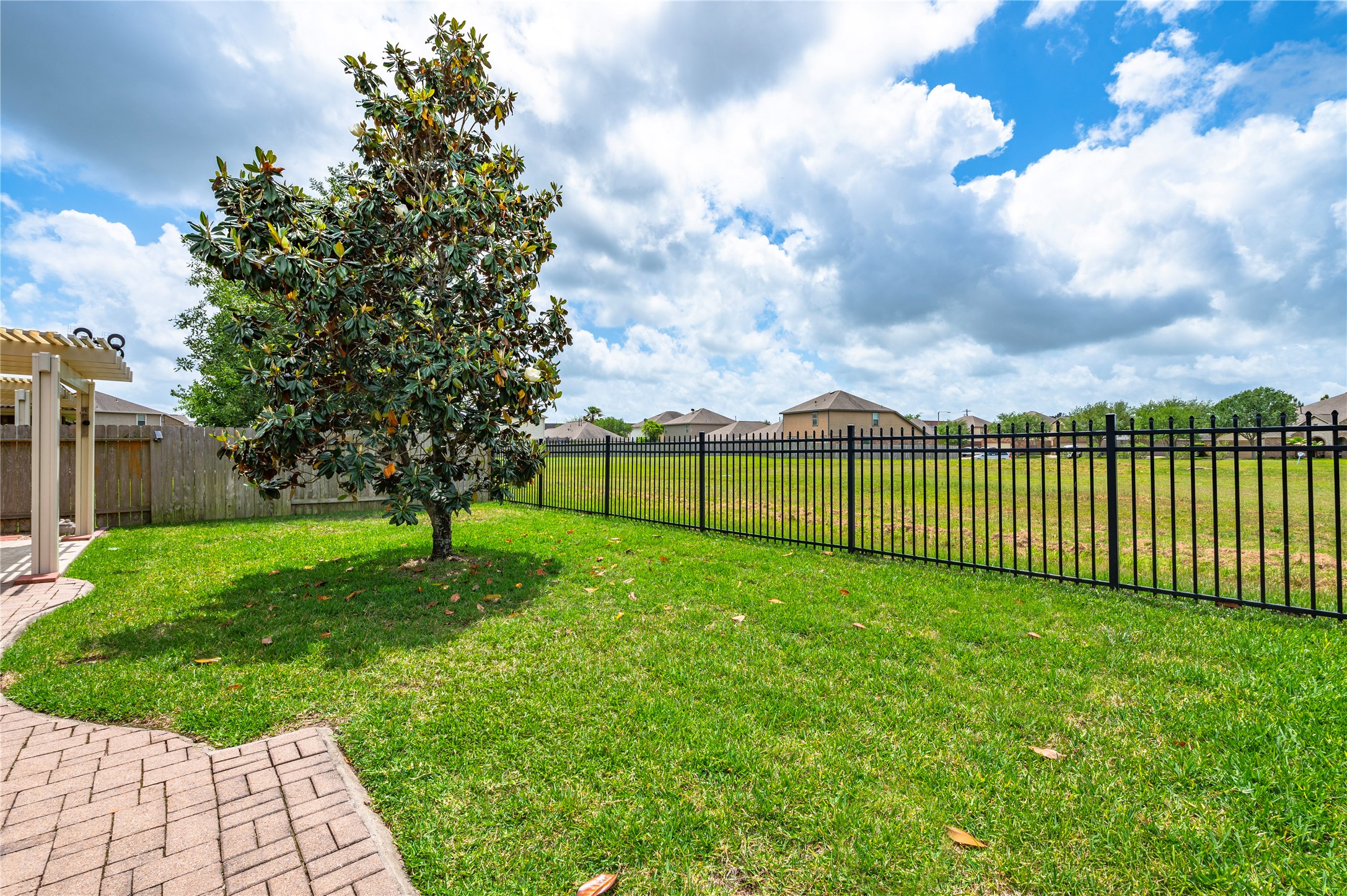 6822 Persea Ridge Lane Dickinson, TX 77539 - Photo 29 of 37 Back yard with Wrought Aluminum Fence on back side and wood fencing on the sides