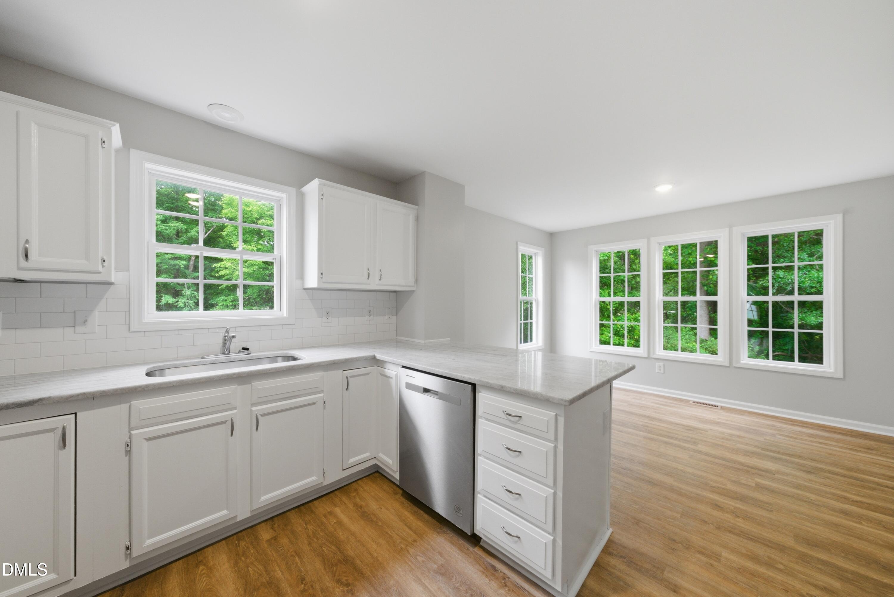 201 Tonylee Court, Unit A Raleigh, NC 27603 - Photo 11 of 30 a kitchen with a sink window and cabinets
