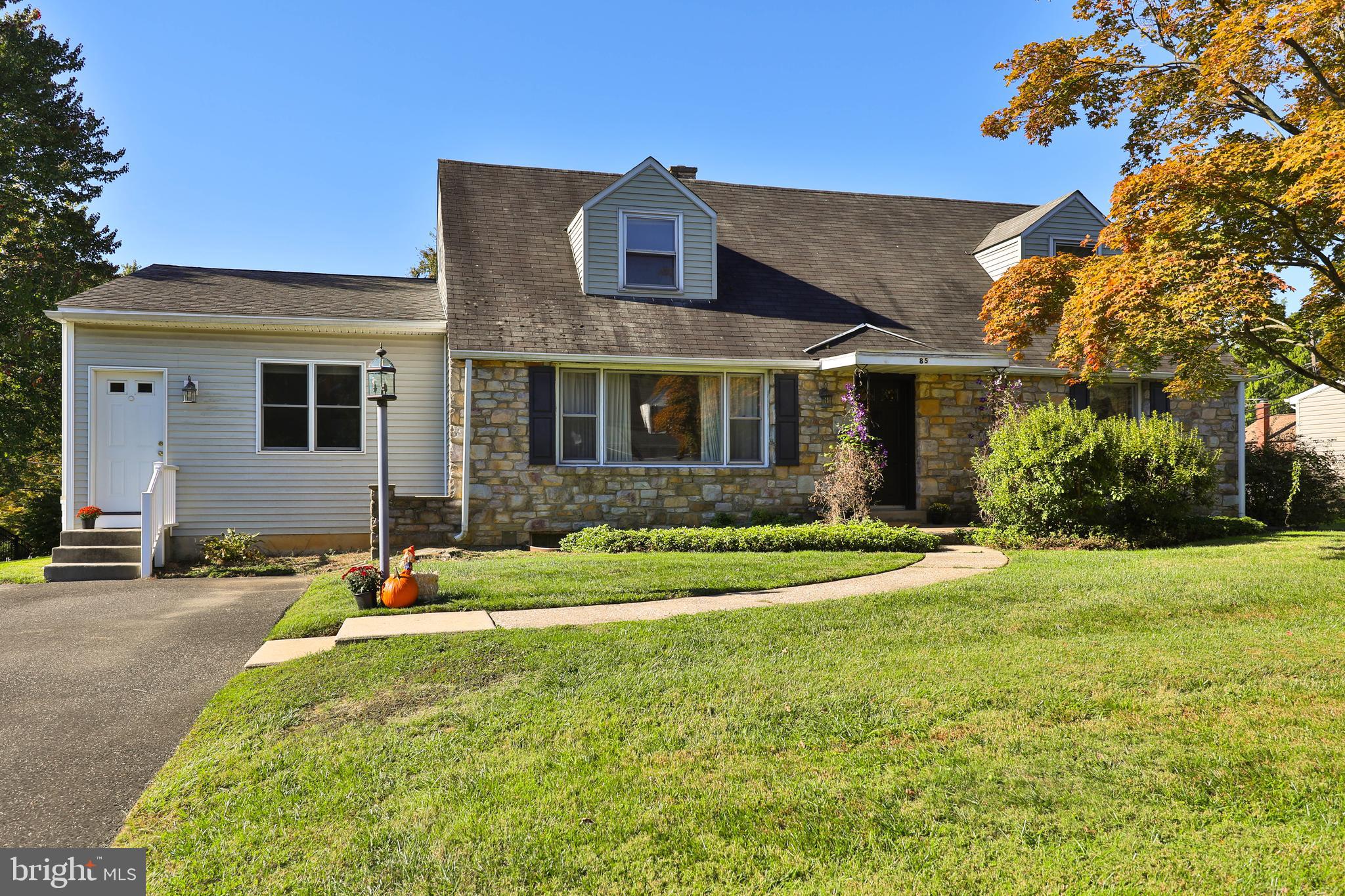 85 Manor Place Oreland, PA 19075 - Photo 2 of 22 a front view of a house with a yard