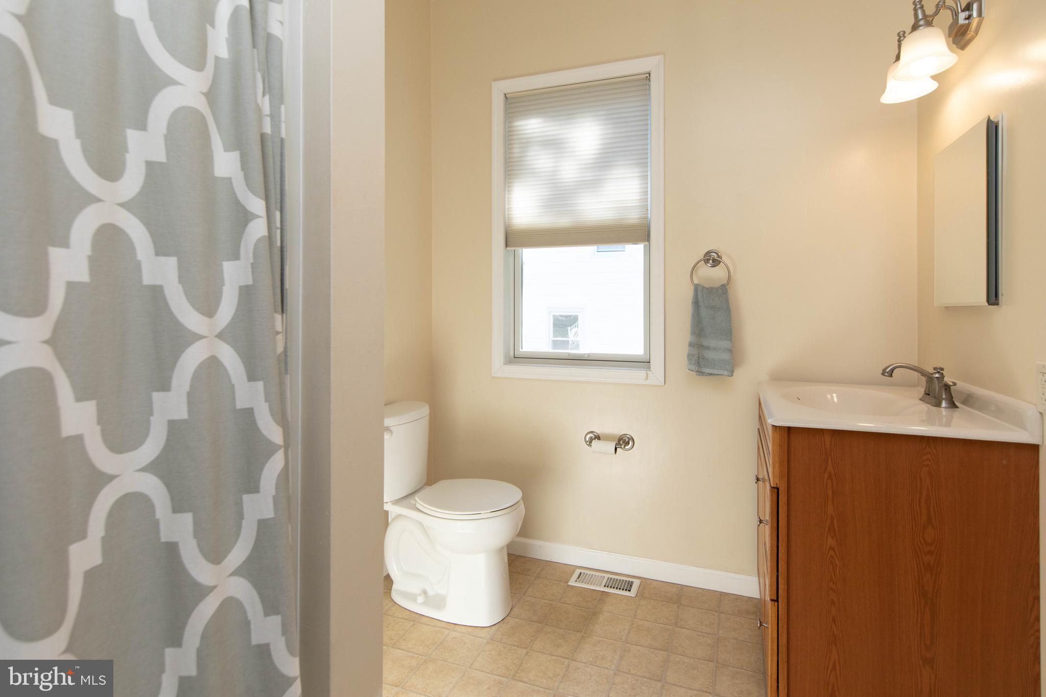 85 Manor Place Oreland, PA 19075 - Photo 10 of 22 a bathroom with a sink and mirror with toilet