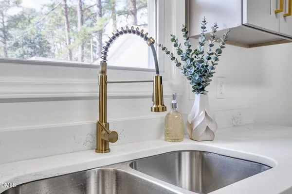 a kitchen with a sink cabinets and window