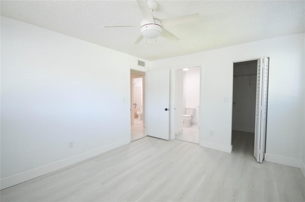 9499 West McNab Road, Unit 208 Tamarac, FL 33321 - Photo 7 of 12 an empty room with fan and entrance