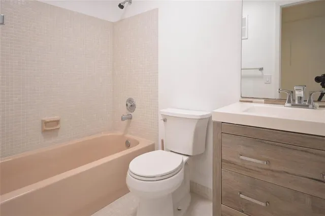 a bathroom with a sink a toilet and bathtub