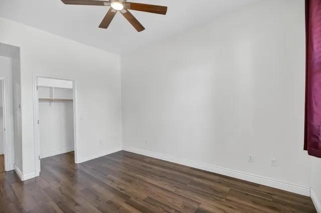 a view of walk in closet with clothes and shoes