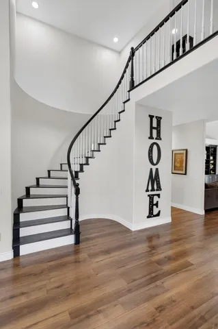 a view of a house with a big yard plants and large tree