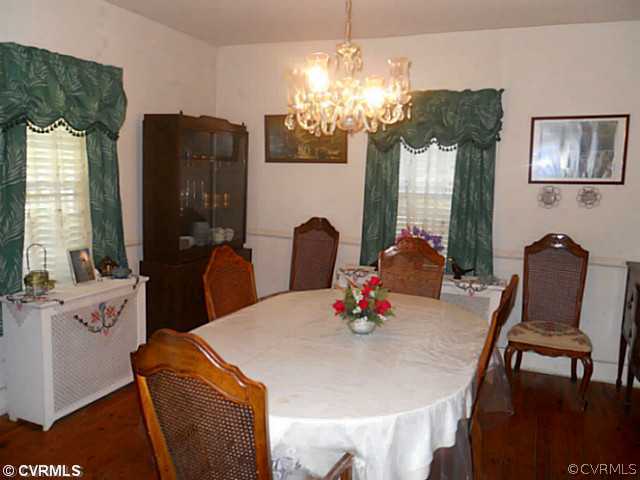 178 Buckner Road Bumpass, VA 23024 - Photo 7 of 16 a dining room with furniture a chandelier and window